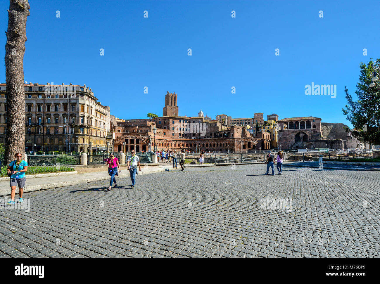 Ancient ruins of Trajan's Market near the Colosseum and Roman Forum on a sunny day as tourists enjoy walking in the historic section of Rome Italy Stock Photo