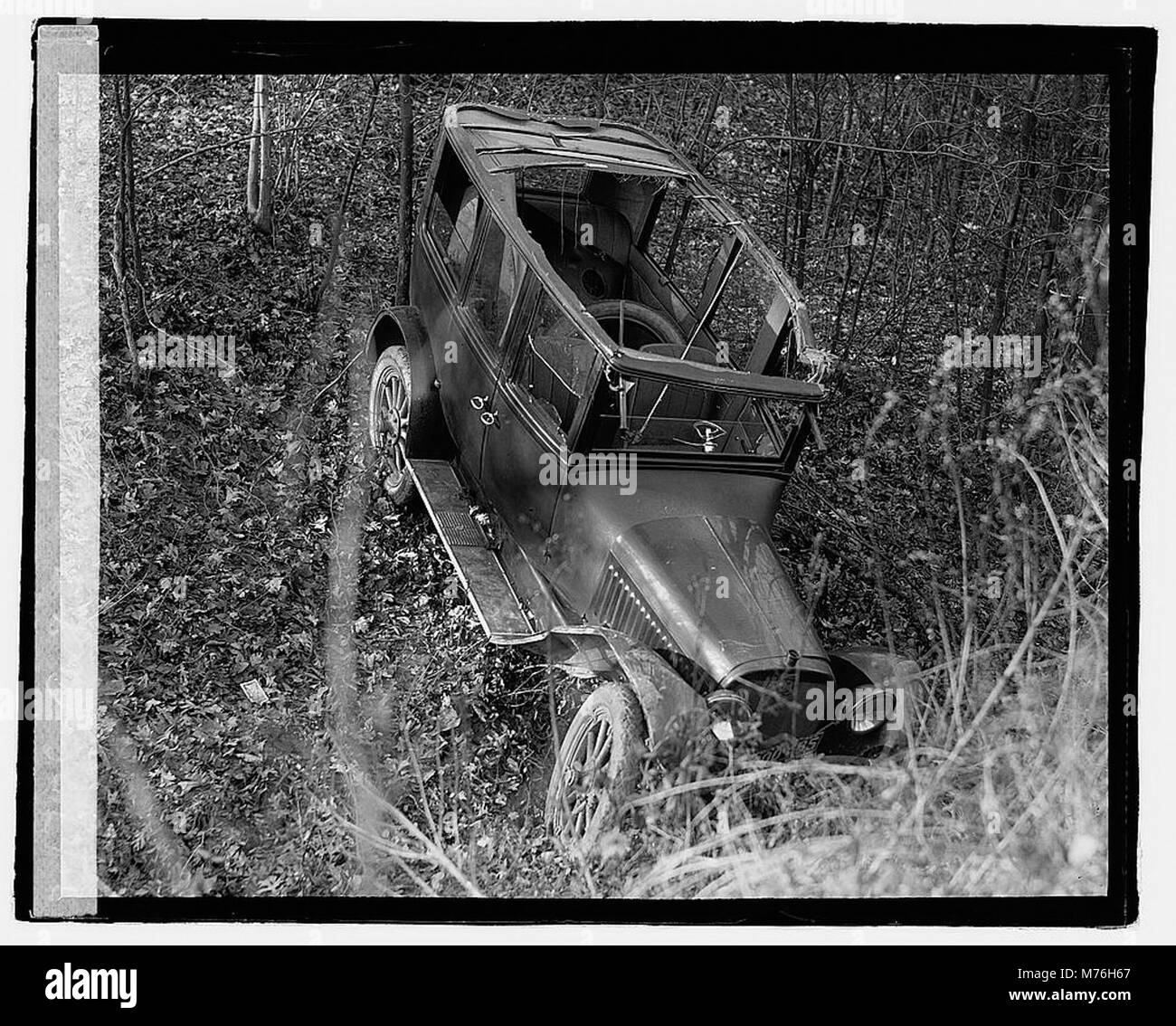 A photograph showing an auto wreck, capturing the aftermath of a car ...