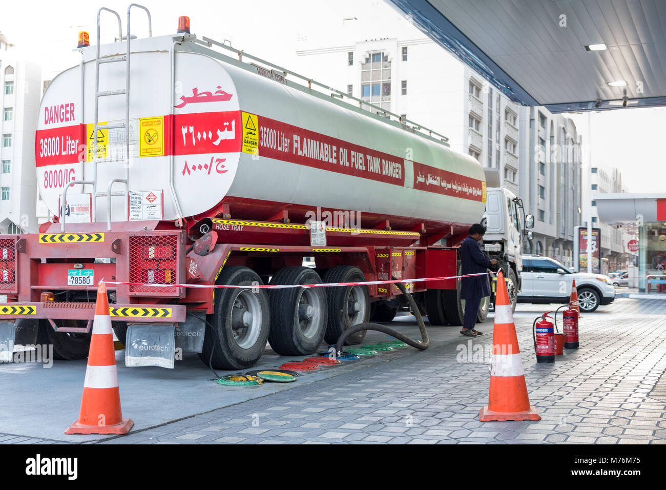 36000 liters Oil Tanker filling underground petrol / diesel tank at ADNOC Patrol Station, Abu Dhabi. Stock Photo