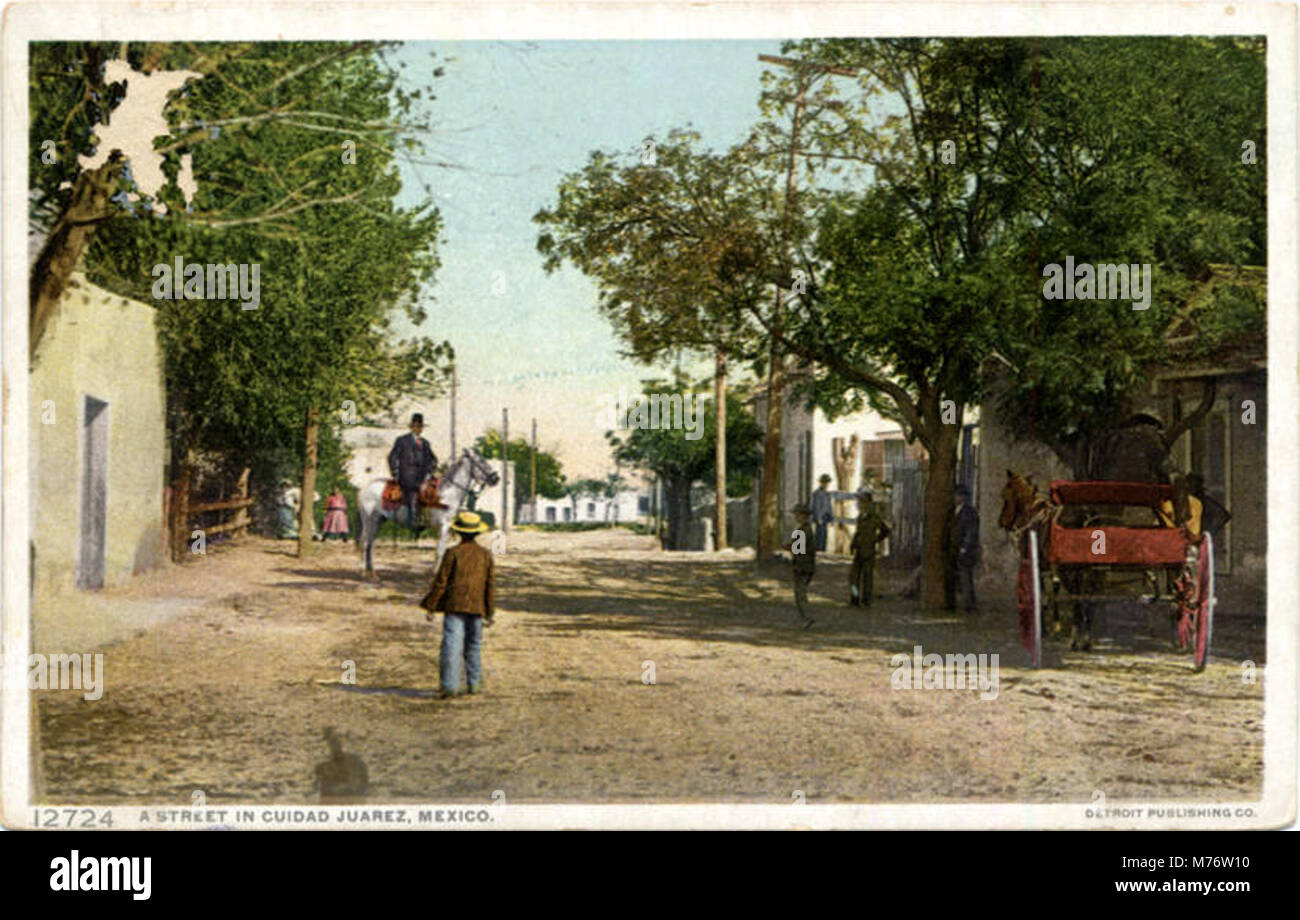 A street scene in Ciudad Juárez, Mexico, showcasing the urban environment and daily life of the region. This image captures the bustling atmosphere of the city in the early 20th century. Stock Photo