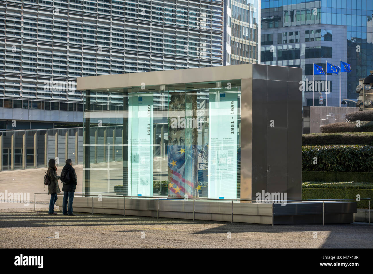 European Commission building, Berlaymont building, Brussels, showcase with part of the Berlin Wall and information panels on the history of the Berlin Stock Photo