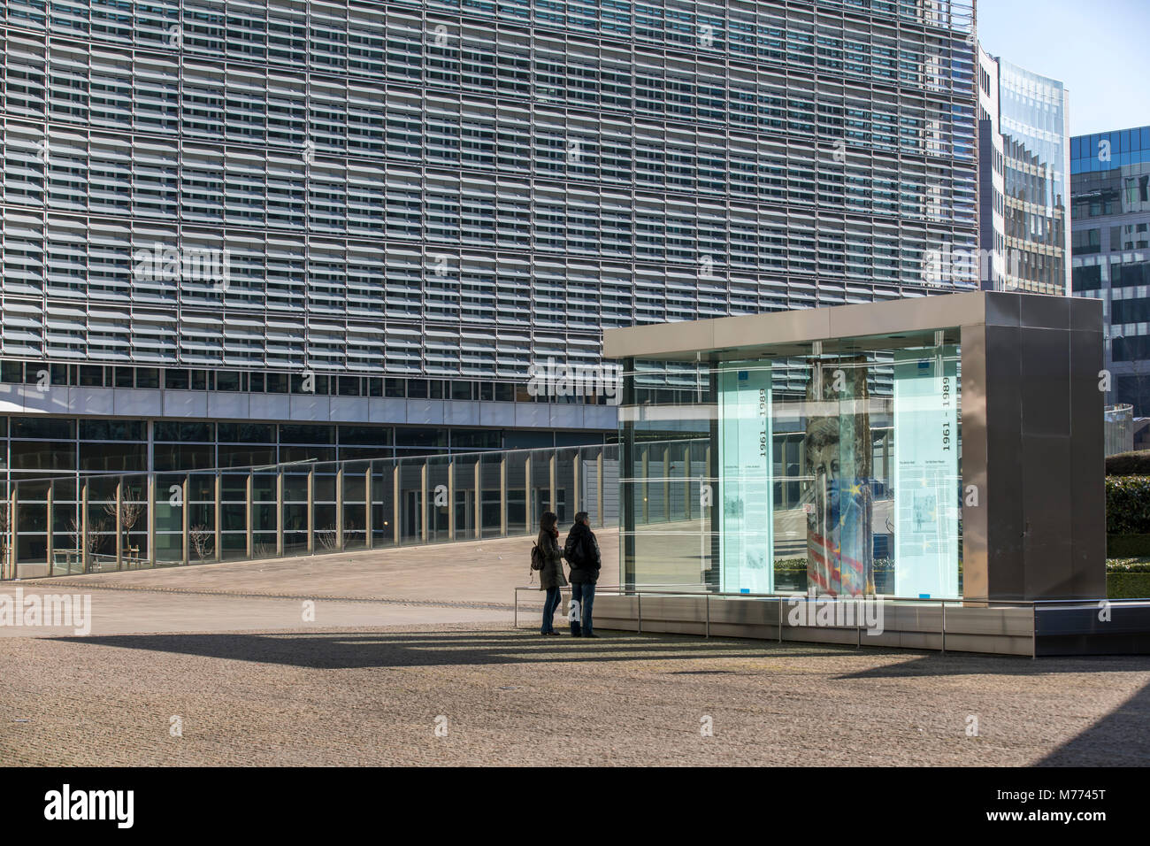 European Commission building, Berlaymont building, Brussels, showcase with part of the Berlin Wall and information panels on the history of the Berlin Stock Photo