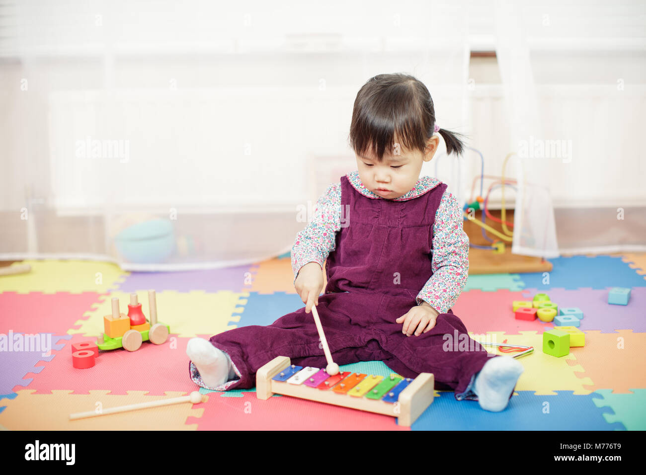 baby girl play xylophone at home Stock Photo Alamy
