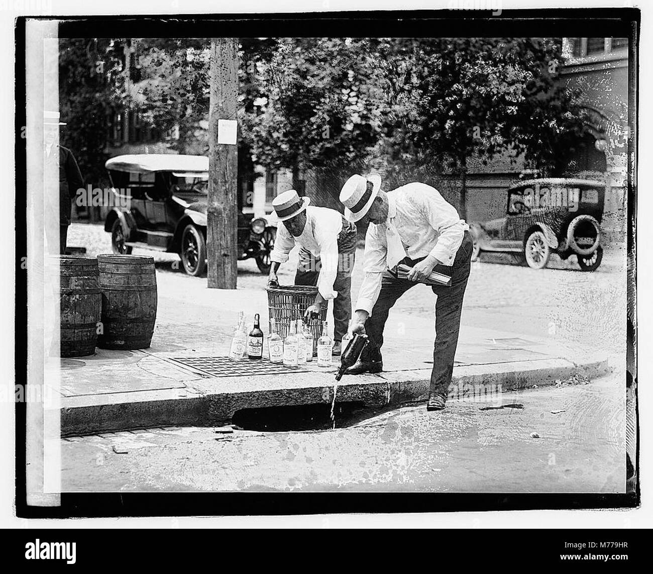 Two men pouring liquor into storm drain), 7821 LOC npcc.04520 Stock