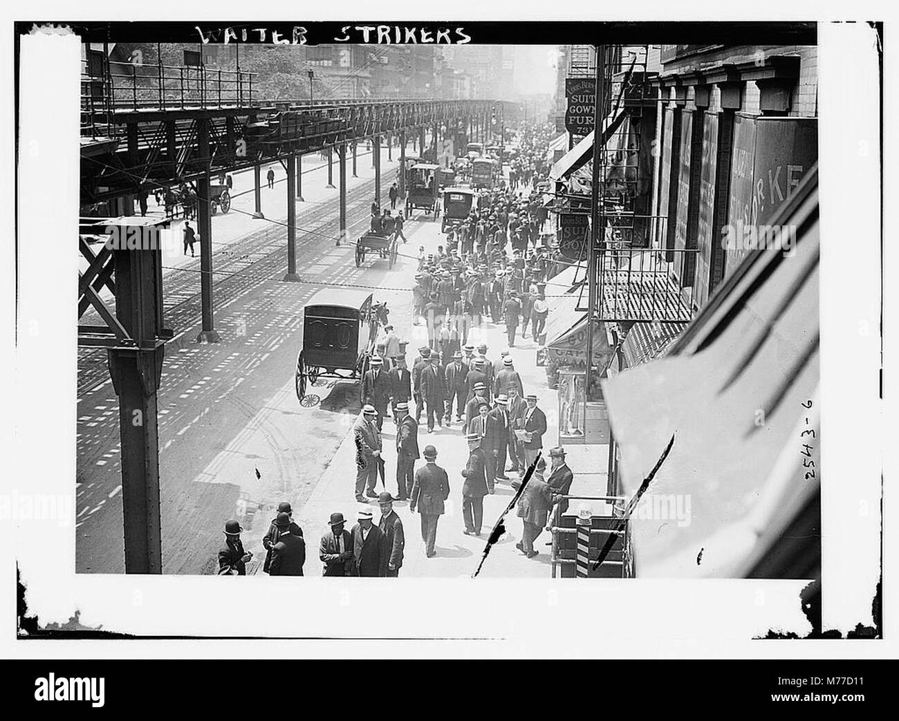 A photograph depicting a group of waiter strikers protesting for better working conditions. The image captures a moment of labor unrest in early 20th-century America. Stock Photo
