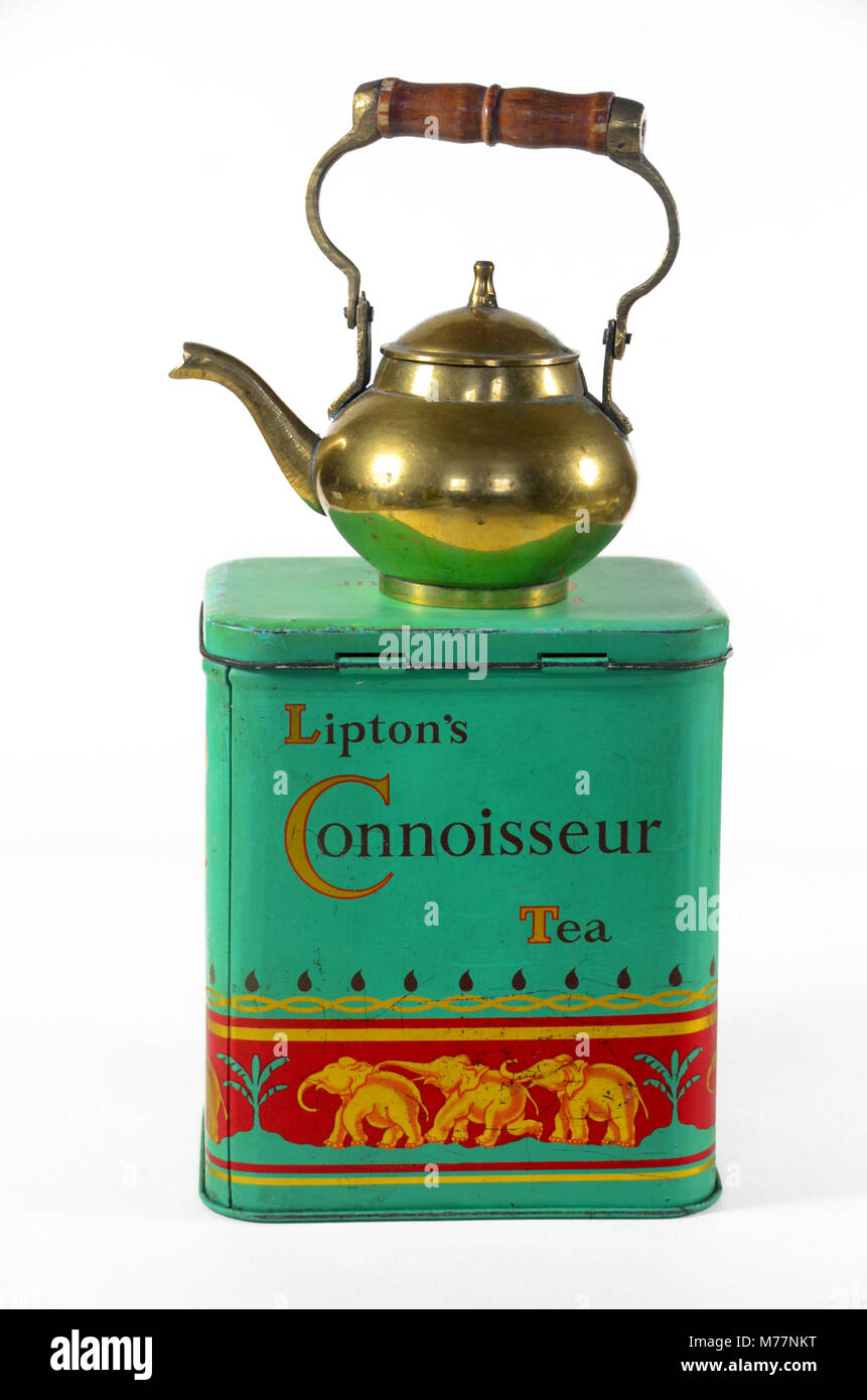 A vintage tin of Lipton's connoisseur tea with brass teapot Stock Photo