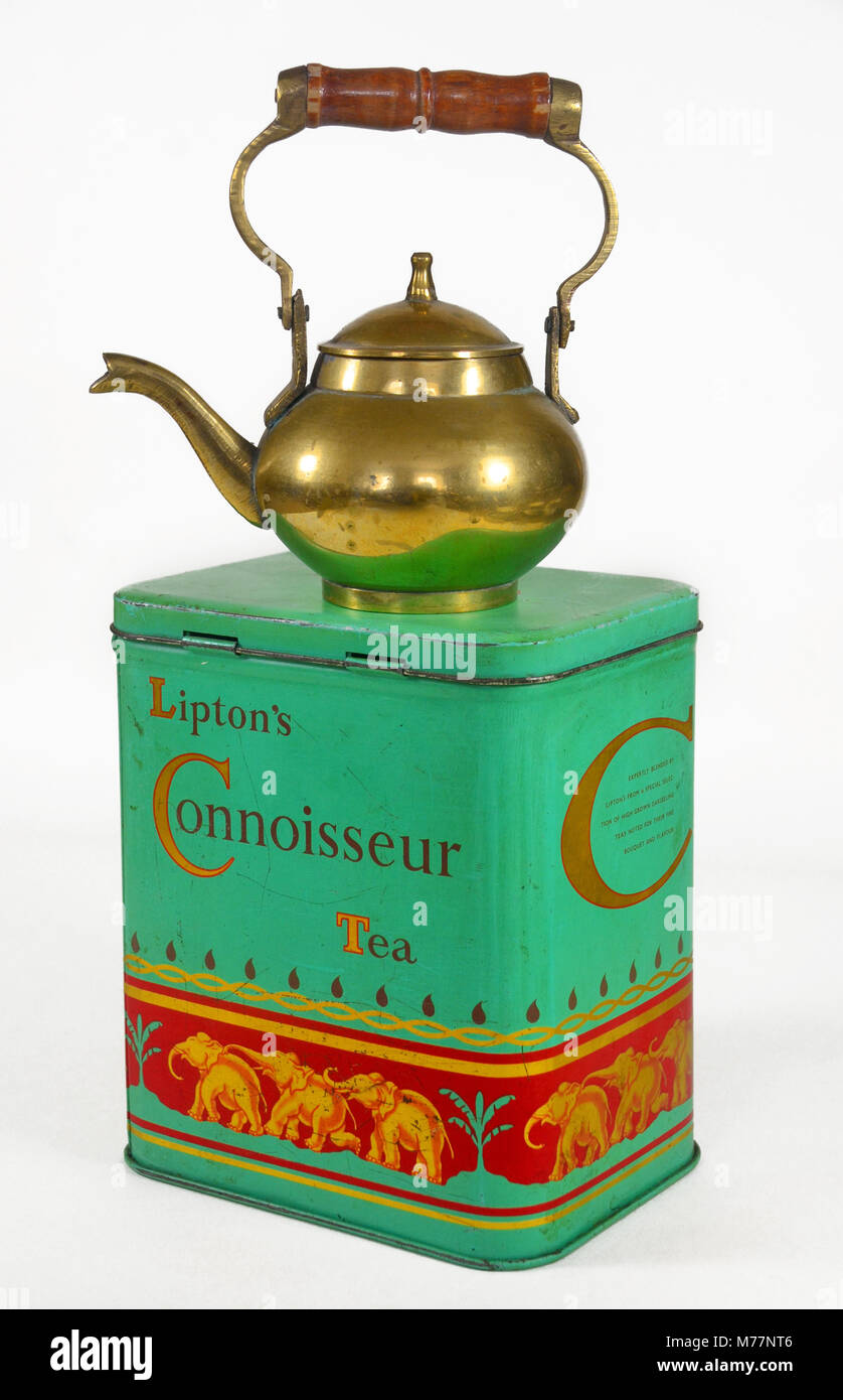 A vintage tin of Lipton's connoisseur tea with brass teapot. Stock Photo
