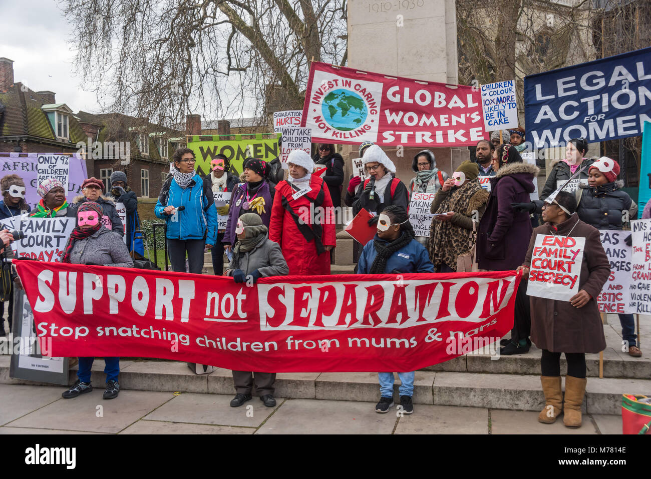 London, UK. 8th March 2018. People beind the main banner 'Support not Separation' at the Global Women's Strike mock trial of the Family Courts in an International Women’s Day protest in front of Parliament. Speakers included mothers who have had children unjustly removed and others who read out shocking comments made in court by judges. portionately aff Credit: Peter Marshall/Alamy Live News Stock Photo