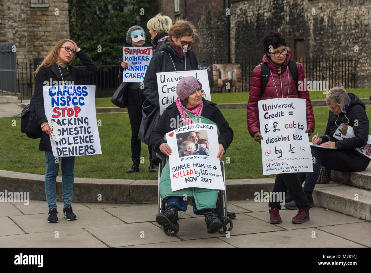 London, UK. 8th March 2018. People with posters at the Global Women's Strike mock trial of the Family Courts in an International Women’s Day protest in front of Parliament. Speakers included mothers who have had children unjustly removed and others who read out shocking comments made in court by judges. The UK has the highest rate of adoptions in Europe, almost all without consent of their birth family. ey say that poverty, oft Credit: Peter Marshall/Alamy Live News Stock Photo