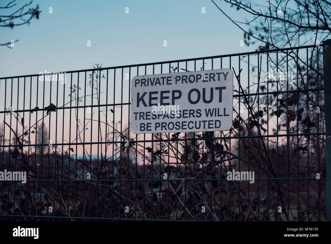 Keep Out sign on the perimeter fence of Dulwich Hamlet Football Club on the 8th March. These signs were put up by property developer Meadows, who own the grounds after their planning application was rejected by Southwark Council. Relations with the DHFC and Meadows  have deteriorated rapidly. Meadows have sent a £121,000 bill for back rent, and trademarked DHFC and Dulwich Hamlet Football Club. They have sent a cease and desist notice and locked DHFC out of the grounds. Stock Photo