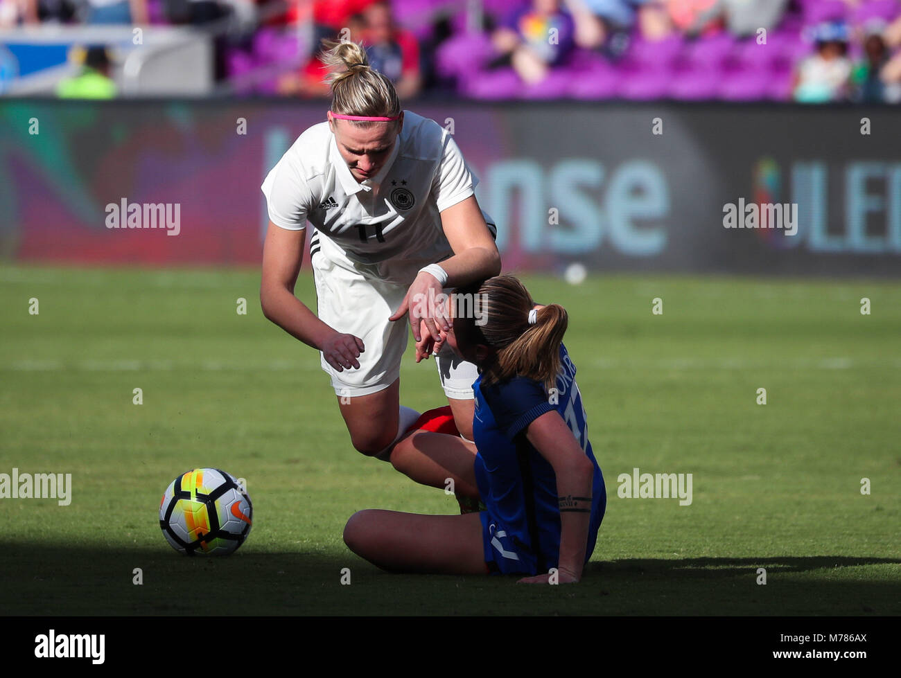 Orlando, Florida, USA. 7th Mar, 2018. Germany forward Alexandra Popp (11) falls over France defender Marion Torrent (17) as they battle for ball possession during the first half of the SheBelieves Cup women's soccer match between the German Women's National Team and the French Women's National Team at the Orlando City Stadium in Orlando, Florida. Credit: Mario Houben/ZUMA Wire/Alamy Live News Stock Photo