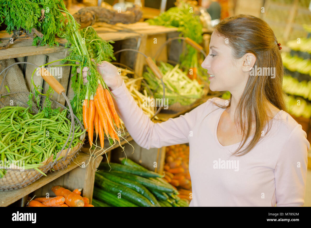 Lady buying fresh carrots Stock Photo