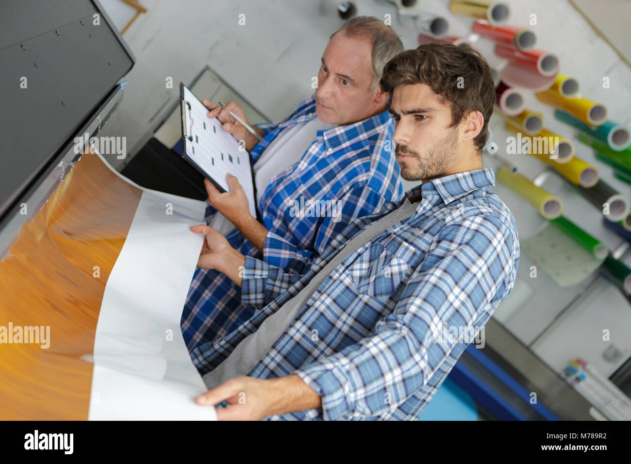 workers on large printer format inkjet working Stock Photo