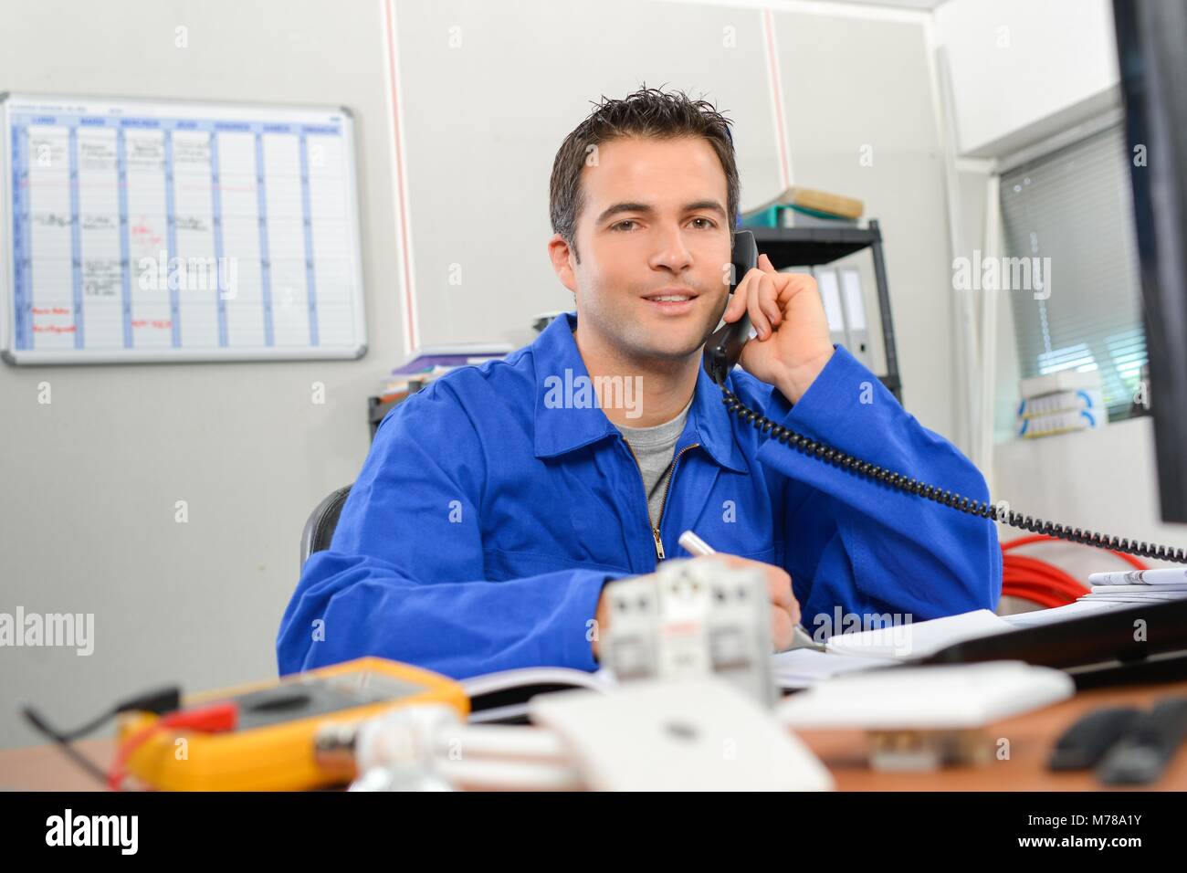 Electrician at his desk Stock Photo