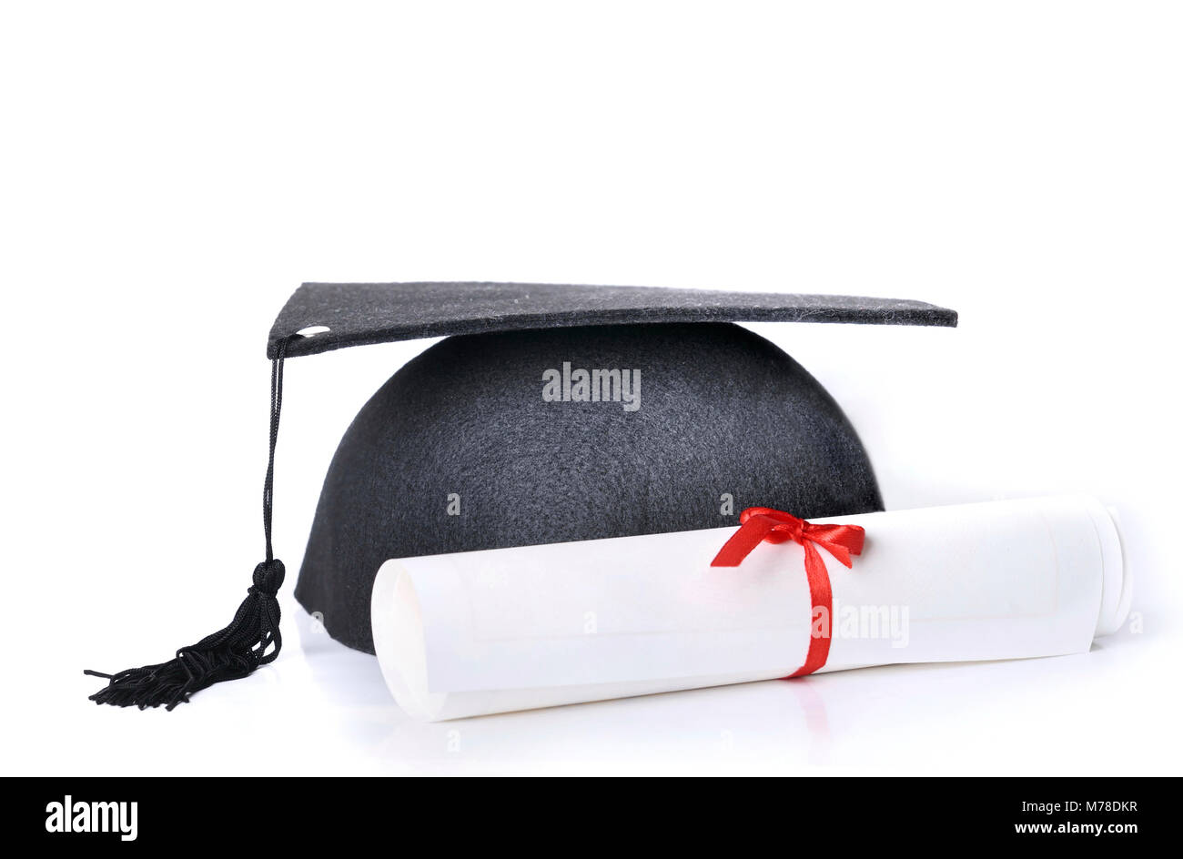 Graduate rolled up in a red ribbon and a black hat on white background ...