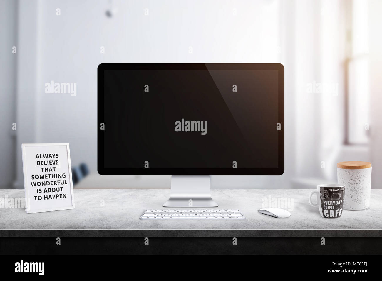 Modern computer display on office desk. Picture frame, box and coffee mug beside. Stock Photo