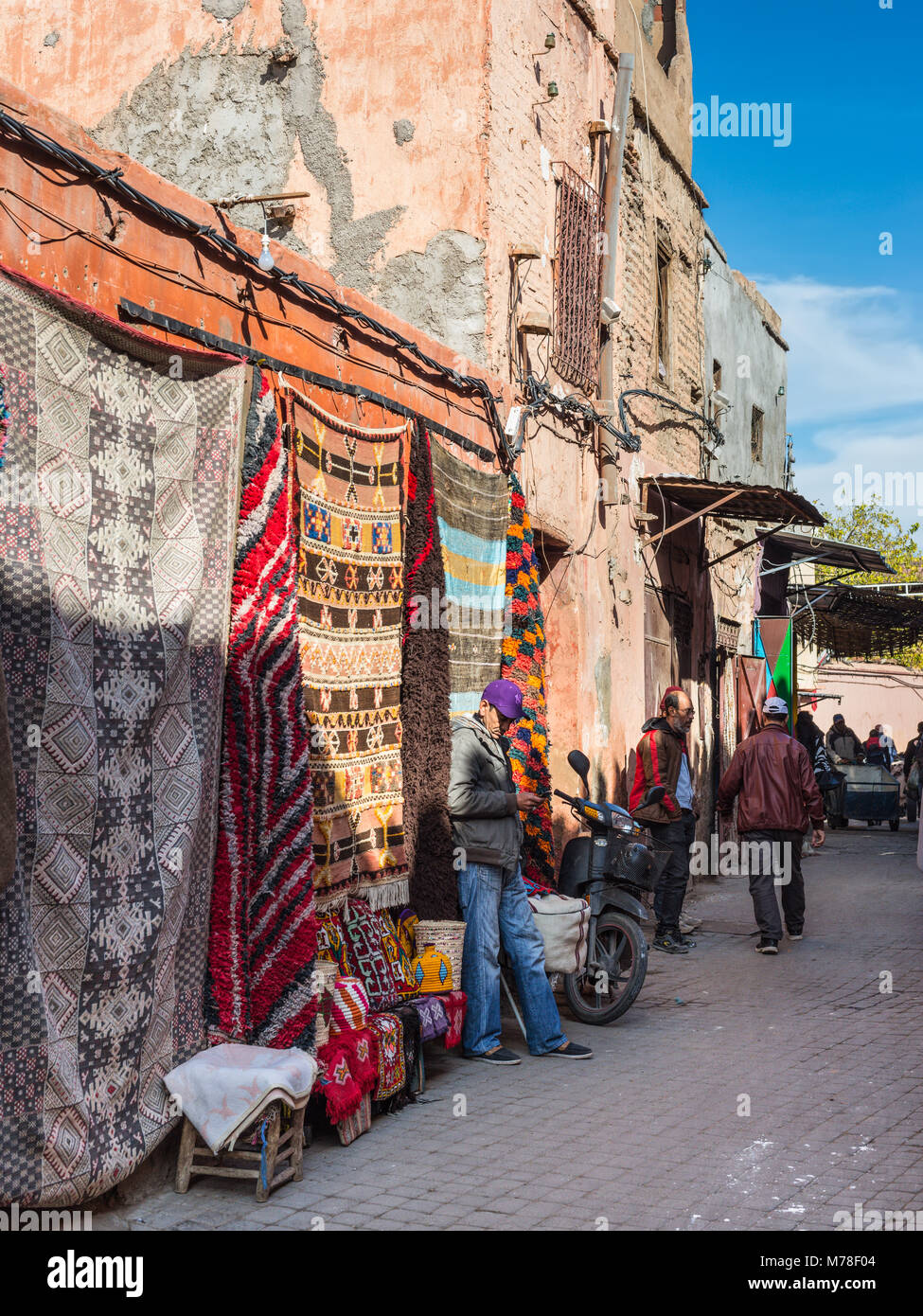 Marrakesh, Morocco - December 8, 2016: Street textile merchants in the famous souks of Marrakesh, Morocco, Africa. Stock Photo