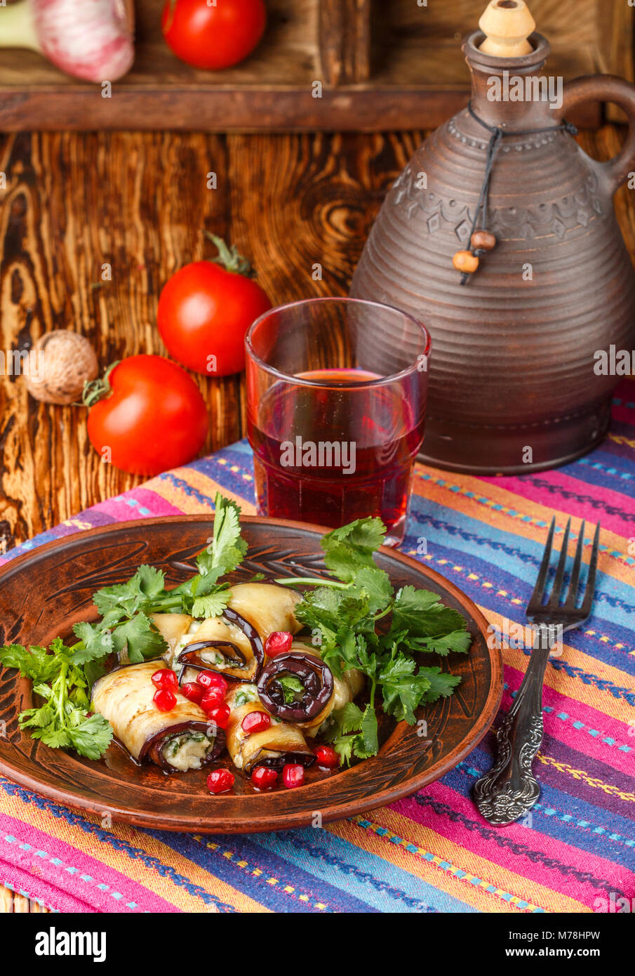 Rolls of fried eggplant with cheese, garlic, cilantro and pomegranate
