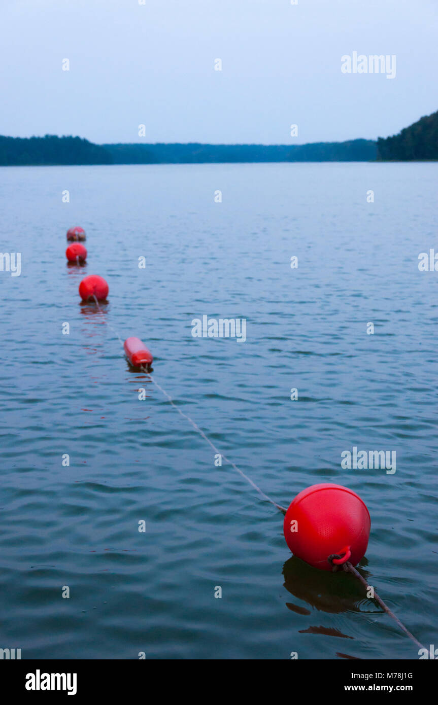 Red buoys on the lake at sunset. Secure swimming area Stock Photo Alamy