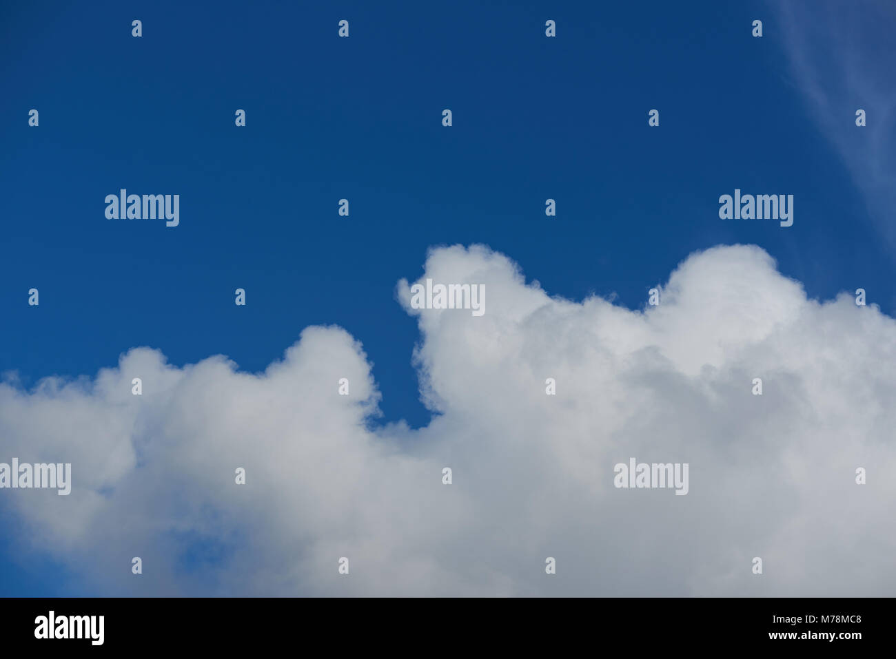 Puffy cloud on blue sky background. Big white cloud on clean blue sky Stock Photo
