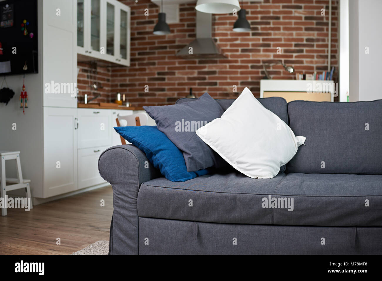 Gray sofa with pillows inside of modern apartments Stock Photo Alamy