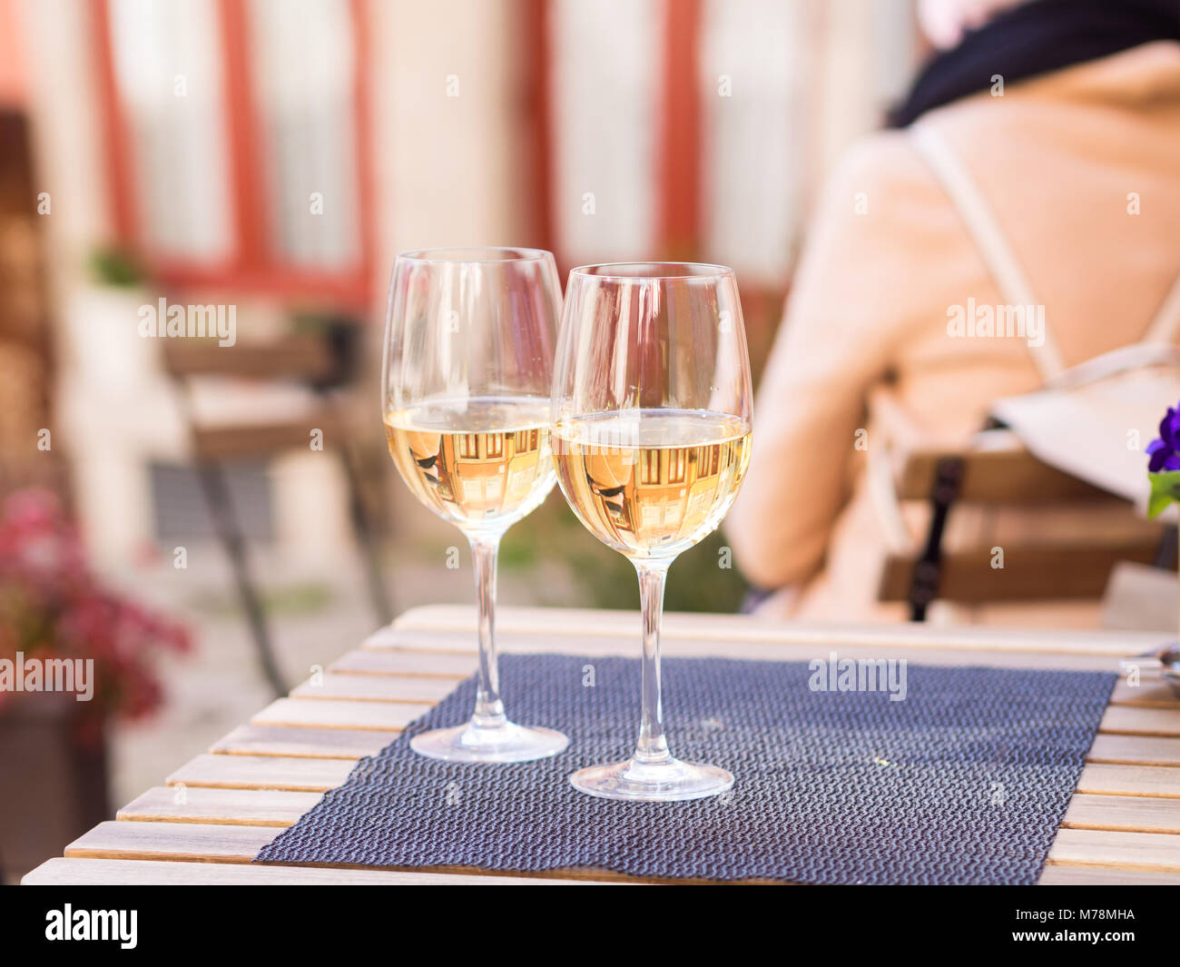 Two glasses of white wine served in a small cafe in the Old Town of Porto, Portugal. Stock Photo