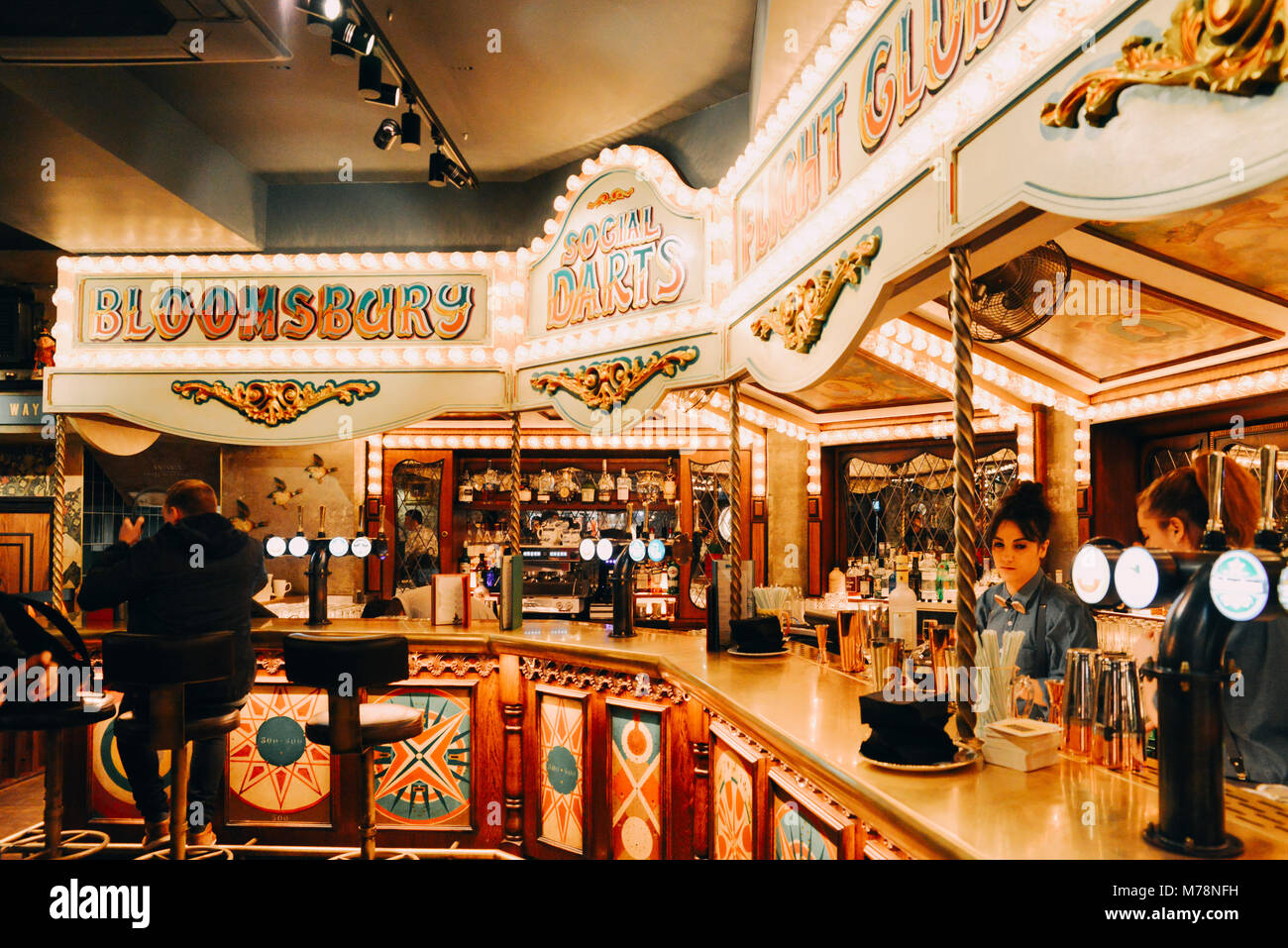 London, UK - Mar 6, 2018: Bright carnival fair style bar at the Flight Cub, a vintage social digital darts club premises in Bloomsbury, London Stock Photo