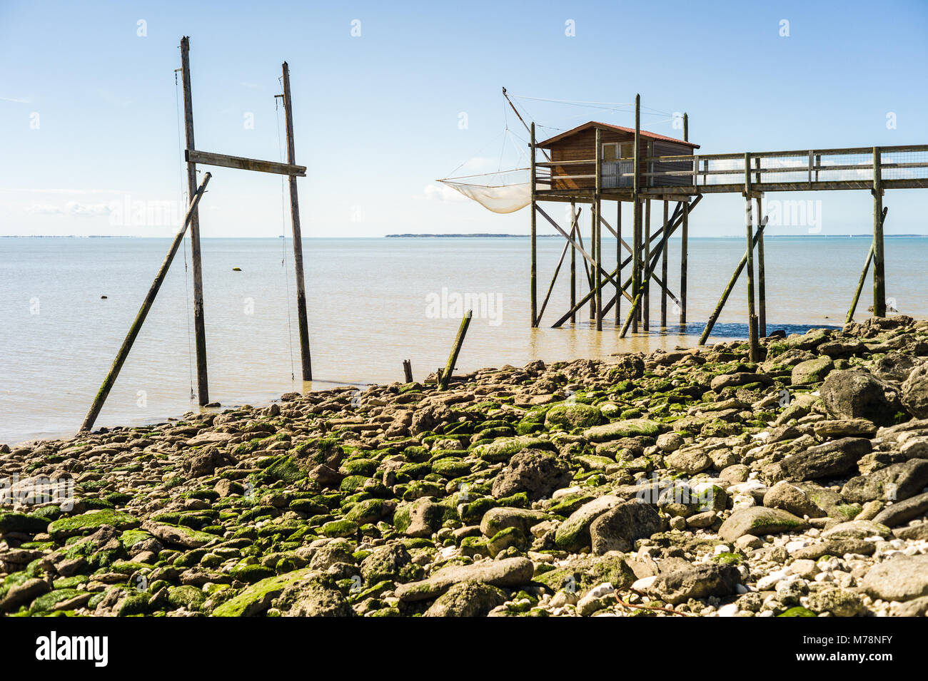 Hut on stilts at low tide for square dipping net fishing, a traditional fishery on the french Atlantic shore. Stock Photo