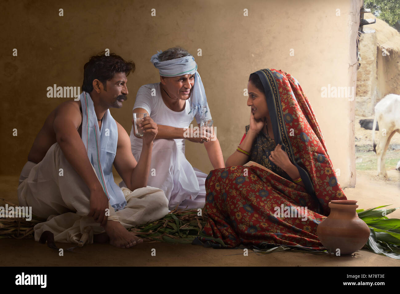 Two farmer talking with rural woman Stock Photo
