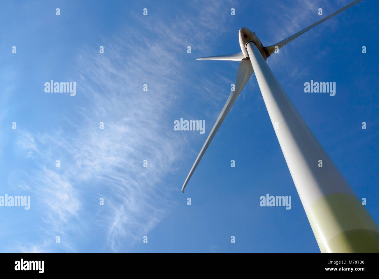 A wind turbine against blue sky and white cloud Stock Photo - Alamy