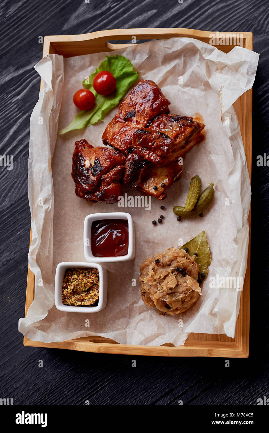 Ribs cooked on the grill with sauerkraut.On parchment paper, decorated