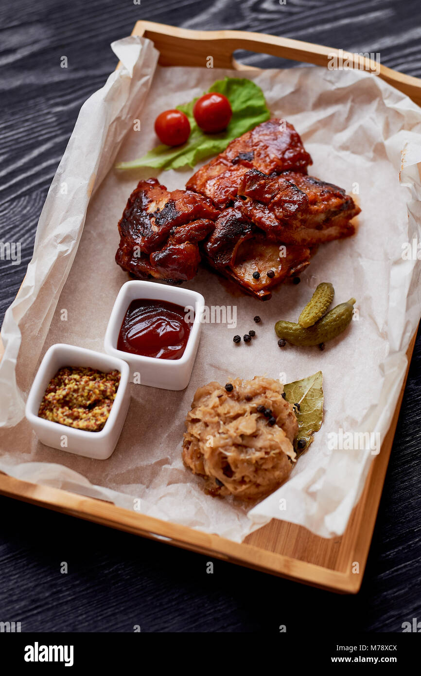 Ribs cooked on the grill with sauerkraut.On parchment paper, decorated