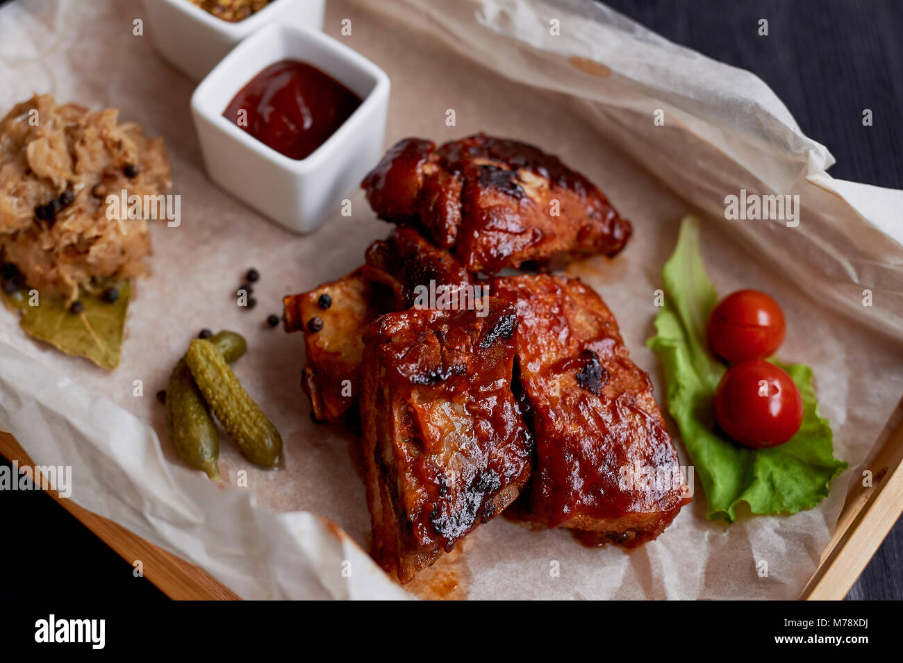 Ribs cooked on the grill with sauerkraut.On parchment paper, decorated