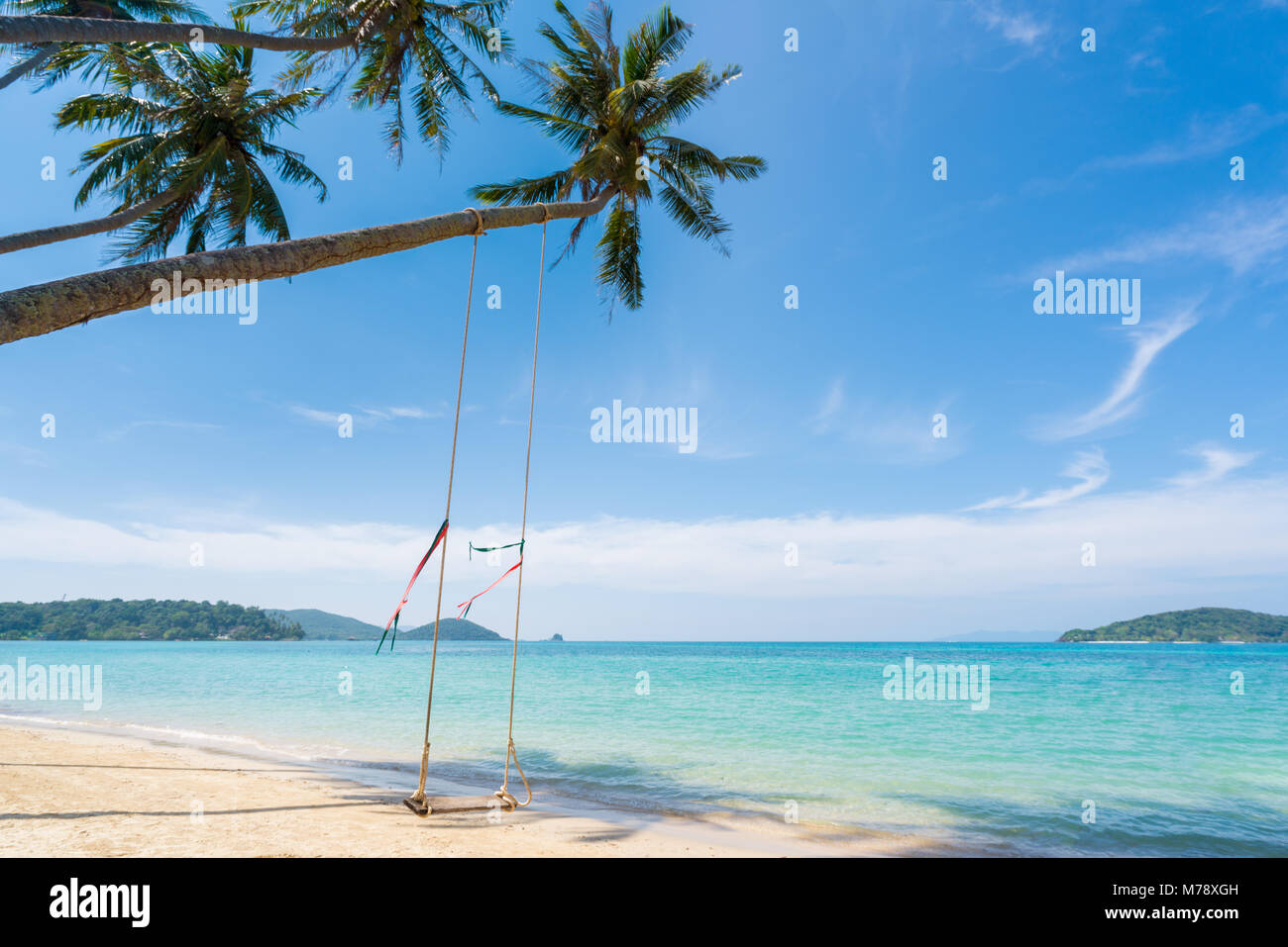 Swing hang from coconut palm tree over summer beach sea in Phuket ,Thailand. Summer, Travel, Vacation and Holiday concept Stock Photo