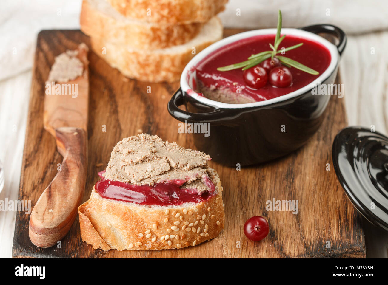 Fresh homemade chicken liver pate (rabbit, goose) with cranberry sauce. Gourmet appetizer. Selective focus Stock Photo