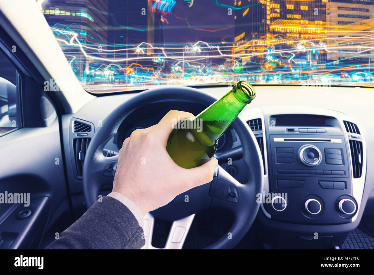 Male Driving A Car At Night With A Bottle Of Beer In His Hand Stock Photo Alamy