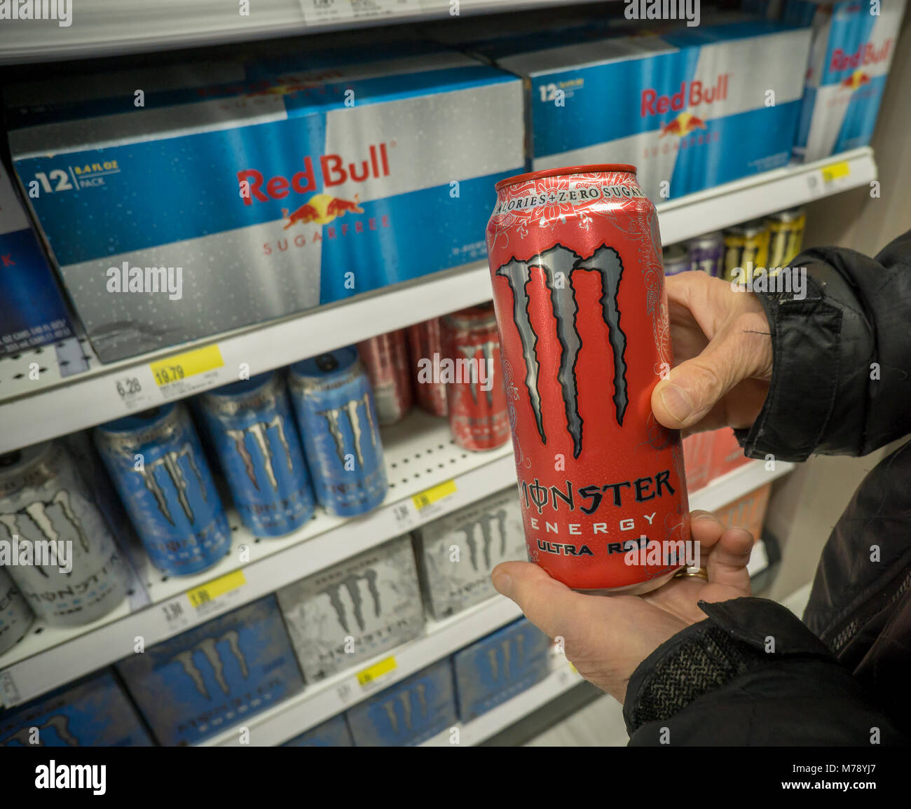 A shopper chooses a can of Monster brand energy drink over its Red Bull competitor in a supermarket in New York on Tuesday, February 27, 2018. Monster Beverages is expected to report fourth-quarter earnings on February 28 after the bell. (Â© Richard B. Levine) Stock Photo
