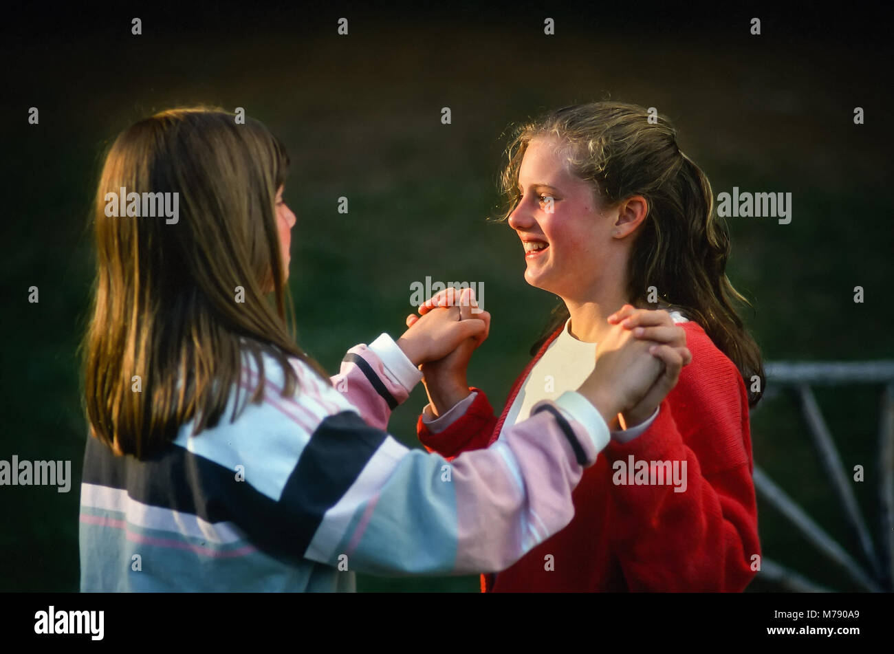 Two happy girl children hold hands at summer camp in Vermont, United States, North America. Stock Photo