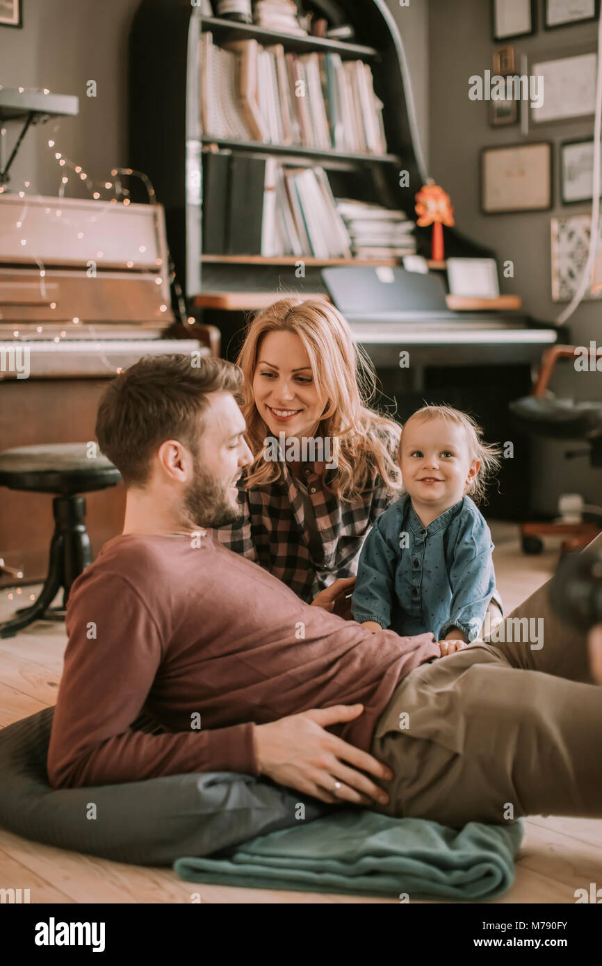 Happy young family playing on the floor  in the room Stock Photo