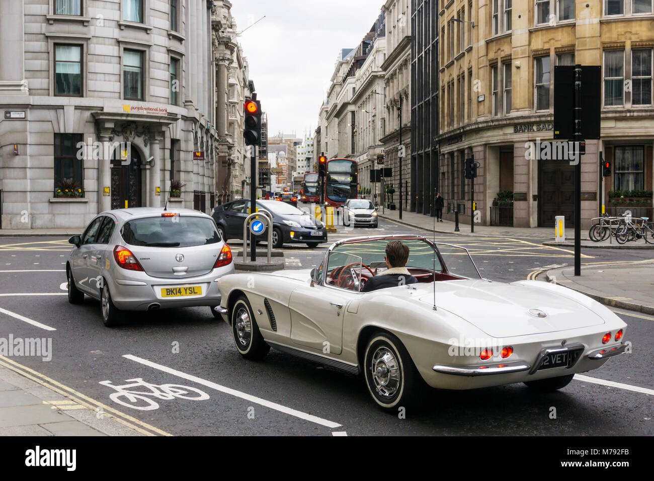A white left-hand drive Chevrolet GMC Corvette at junction of Princes Street and Lothbury in the City of London. Stock Photo