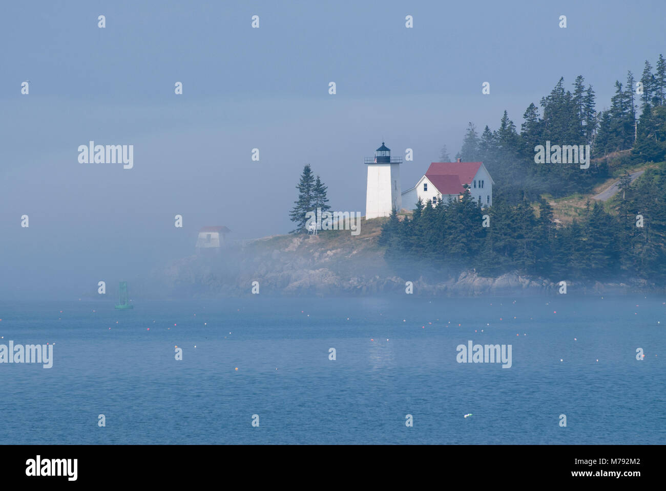 Burnt Coat Harbor lighthouse of Swan’s Island in Maine, is illuminated ...