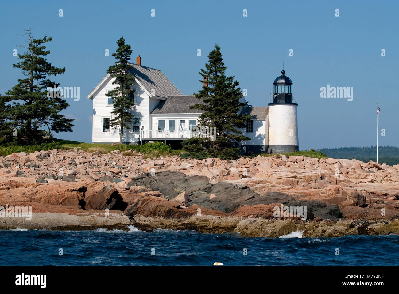 Winter Harbor lighthouse is an island beacon in down east Maine, on a summer day near Acadia National Park. Stock Photo