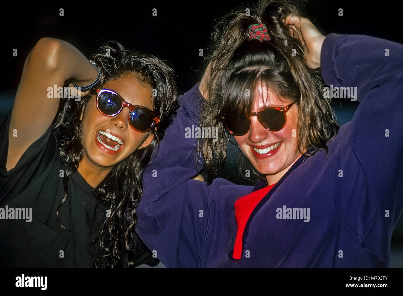 Two teenage girls in sunglasses laugh and primp at summer camp in Vermont, United States, North America. Stock Photo
