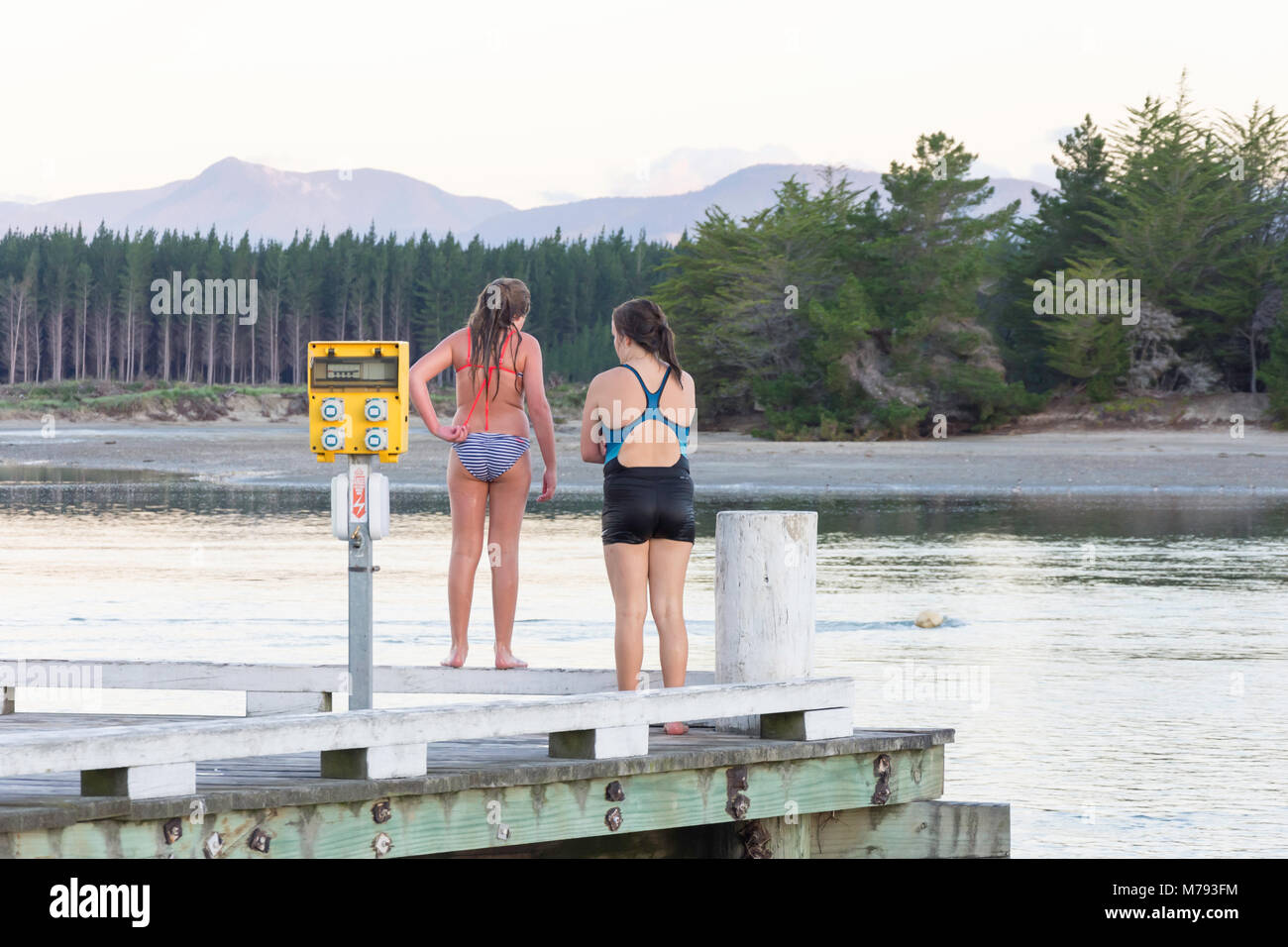 Children jumping off wharf at sunset, Mapua Wharf, Mapua, Tasman