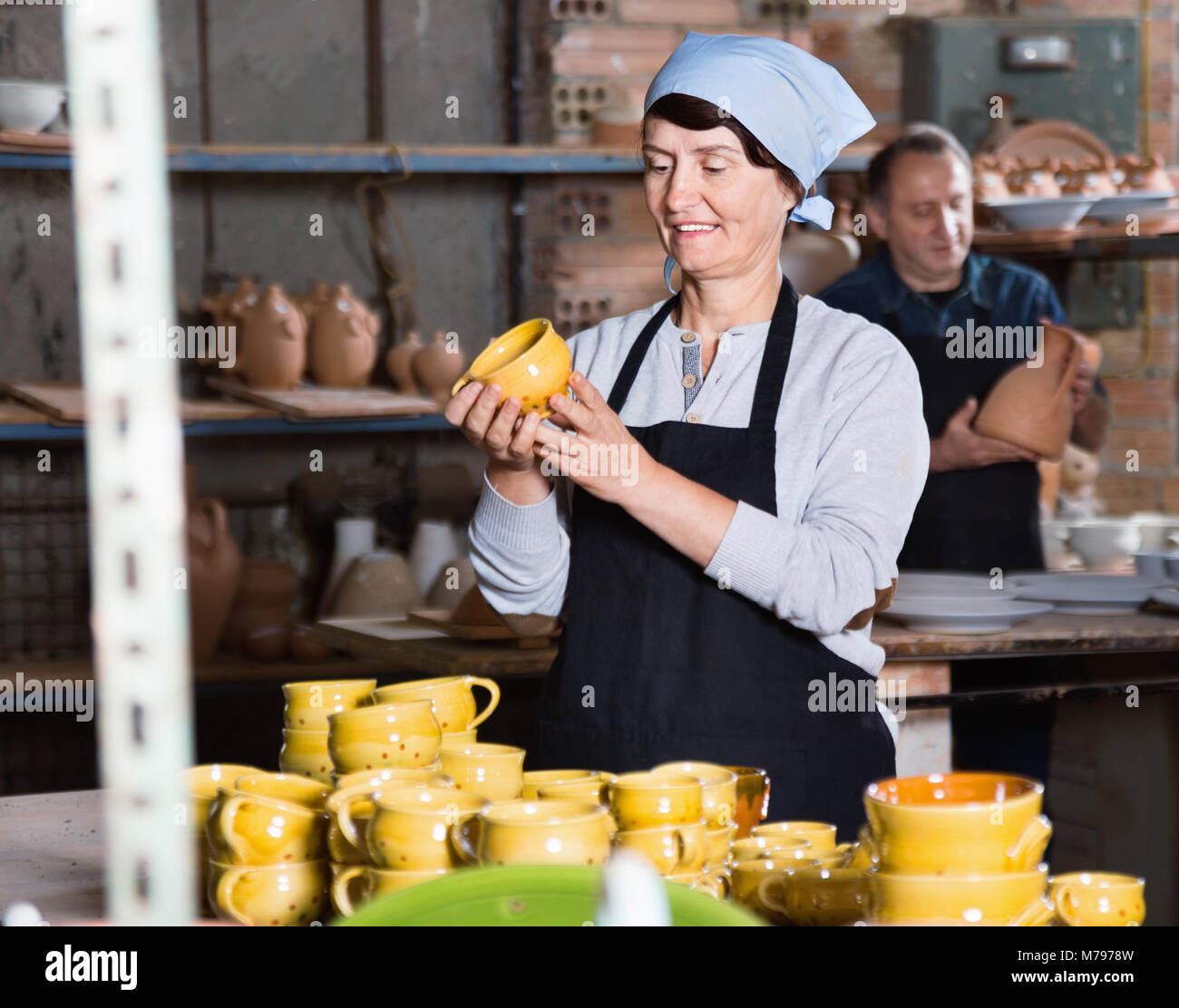 Two glad smiling potters in the process of work at the workshop Stock ...