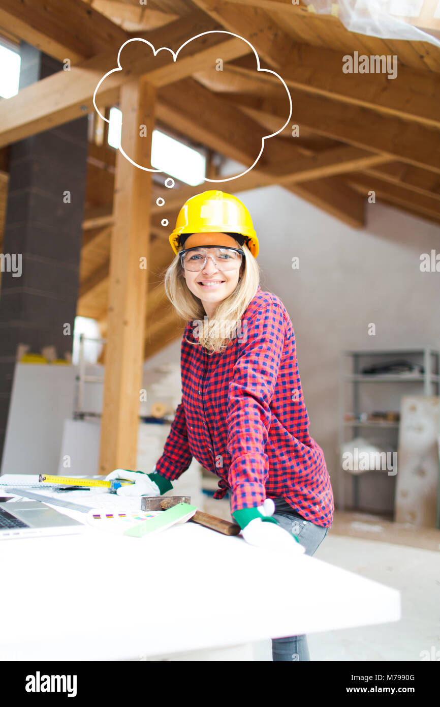 beautiful woman with yellow helmet is working in her loft Stock Photo ...
