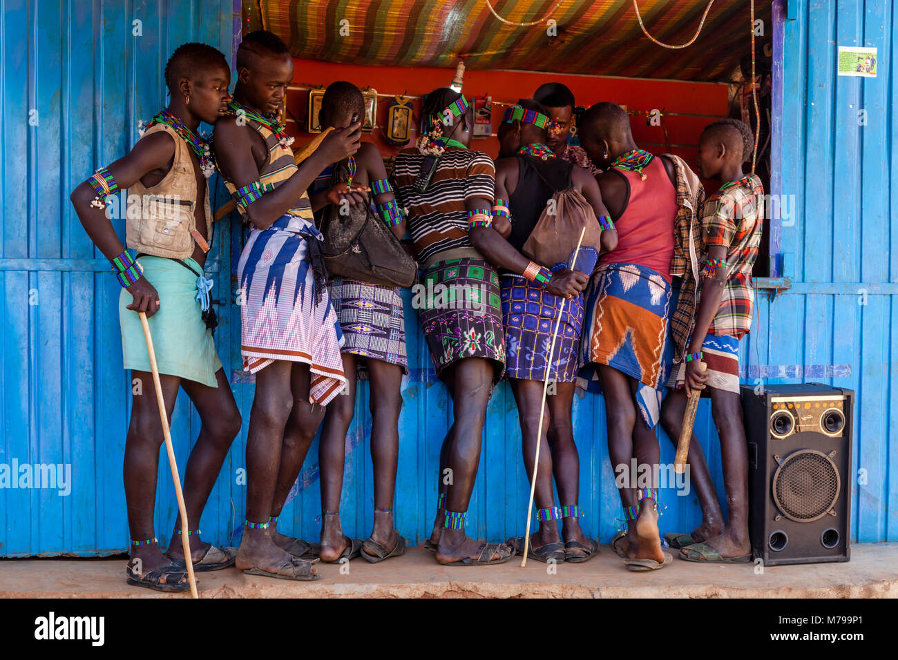 Young Hamar Men Outside A Mobile Phone (Cell Phone) Shop During Their Weekly Visit To The Tribal Market In Dimeka, Omo Valley, Ethiopia Stock Photo