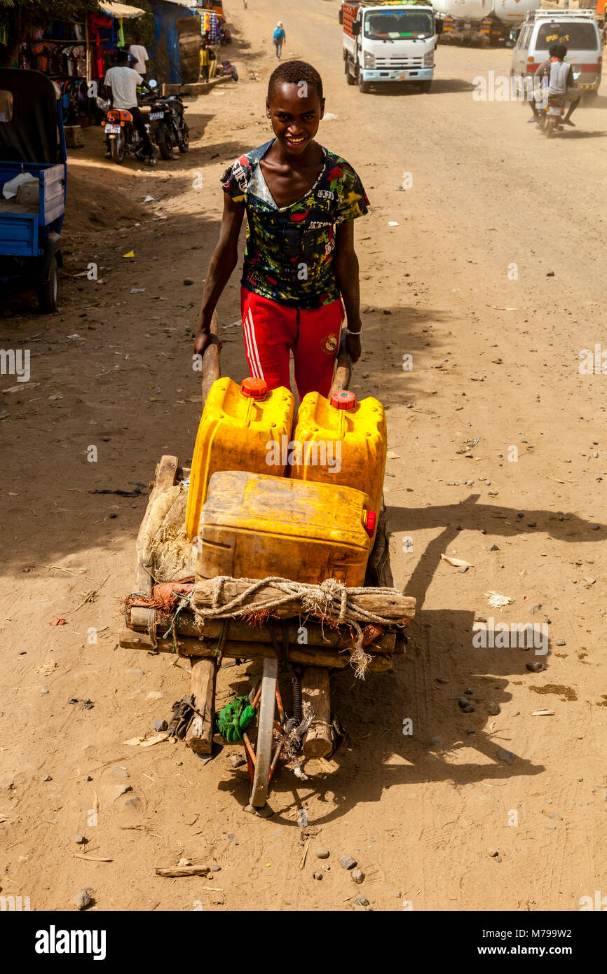 Local Boys Transporting Water In The Town Of Jinka, Omo Valley, Ethiopia Stock Photo