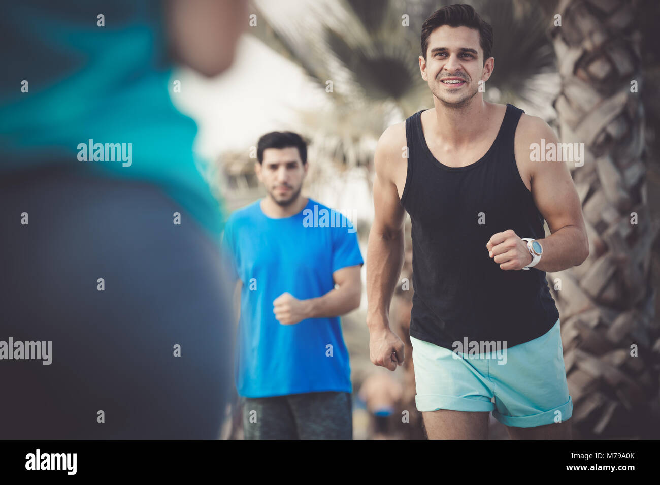 Two friends are doing race in time training in the park near sea Stock ...