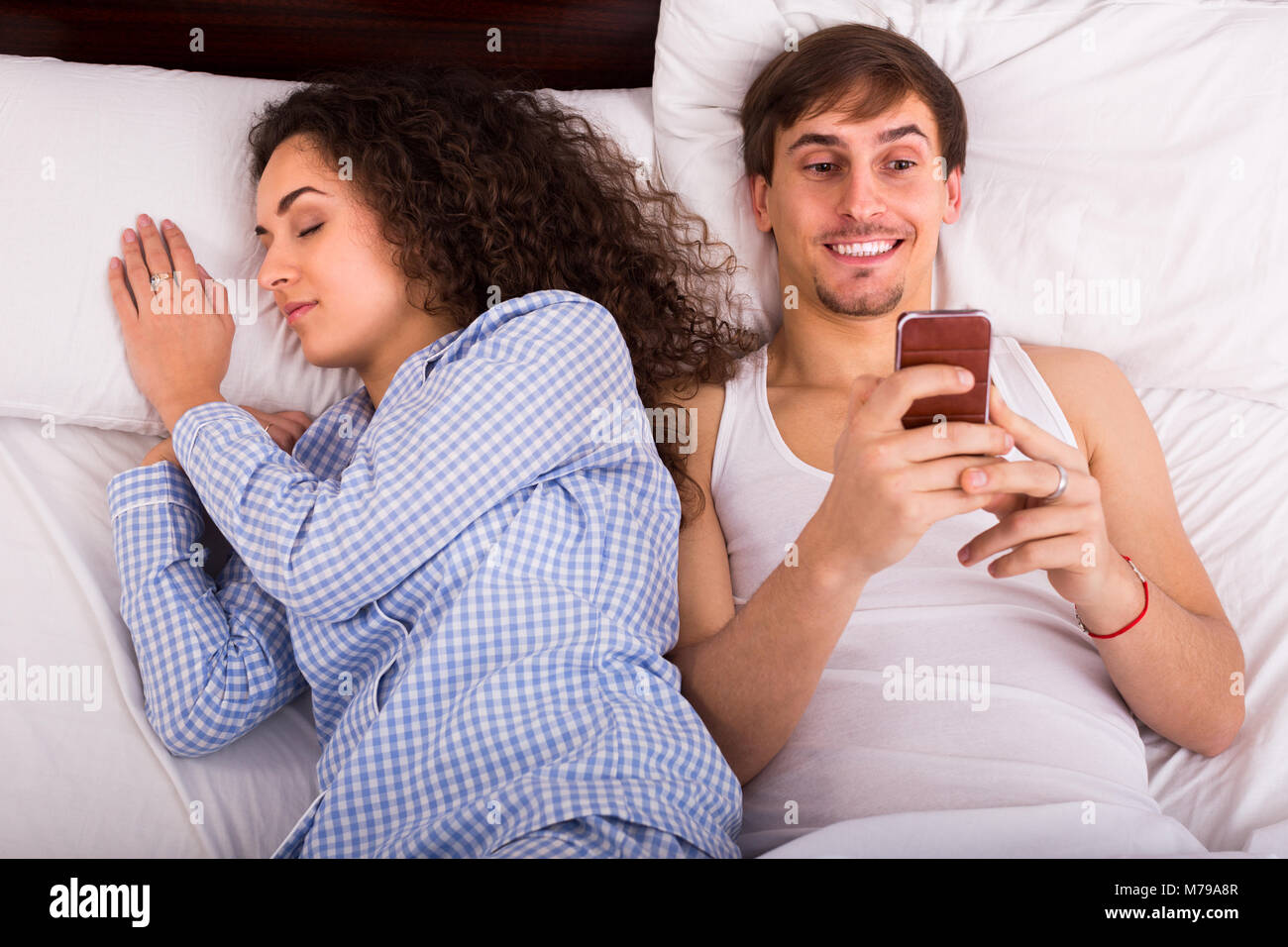 Couple In Bedroom Woman Writing Stock Photos Couple In